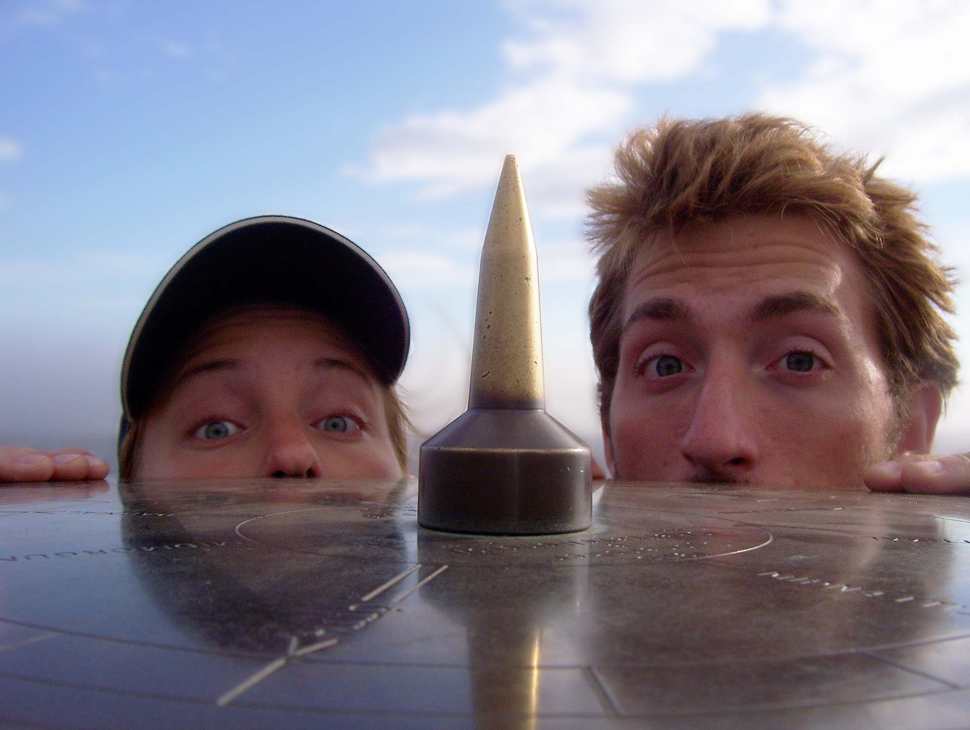 ash and nat peeking over compass