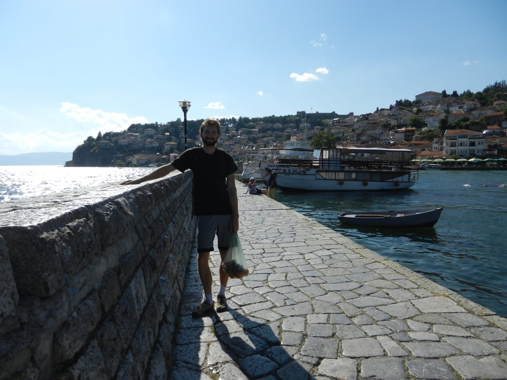 Nathanael with an bag o' fruit on the beautiful waters of Lake Ohrid